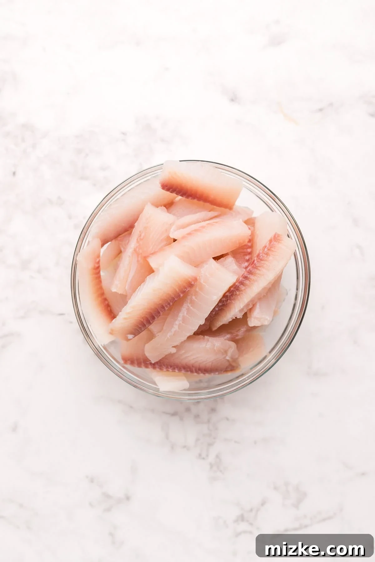 Crispy Air Fryer Fish Sticks 4 raw fish cut into stick shapes