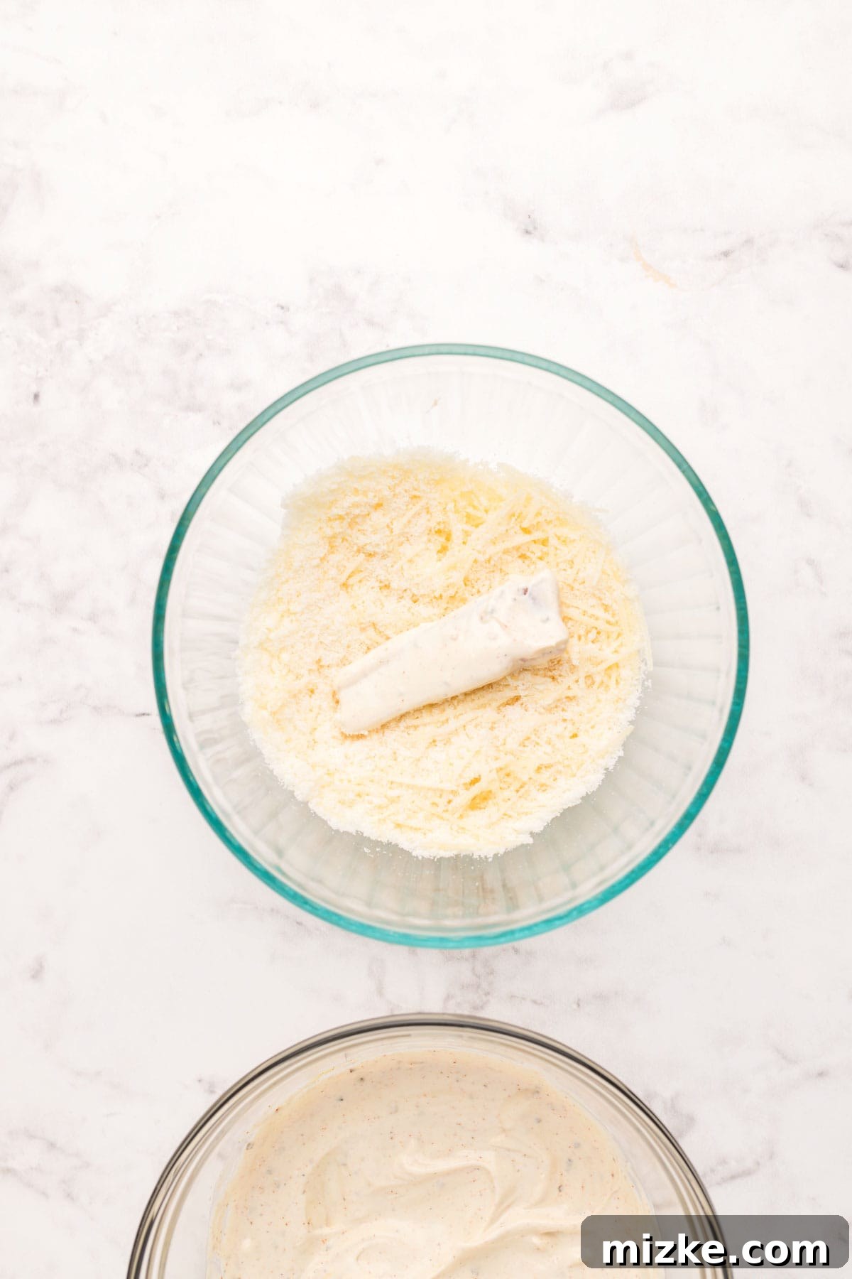 Crispy Air Fryer Fish Sticks 6 fish stick covered in mayo in a mixture of parmesan cheese and breadcrumbs