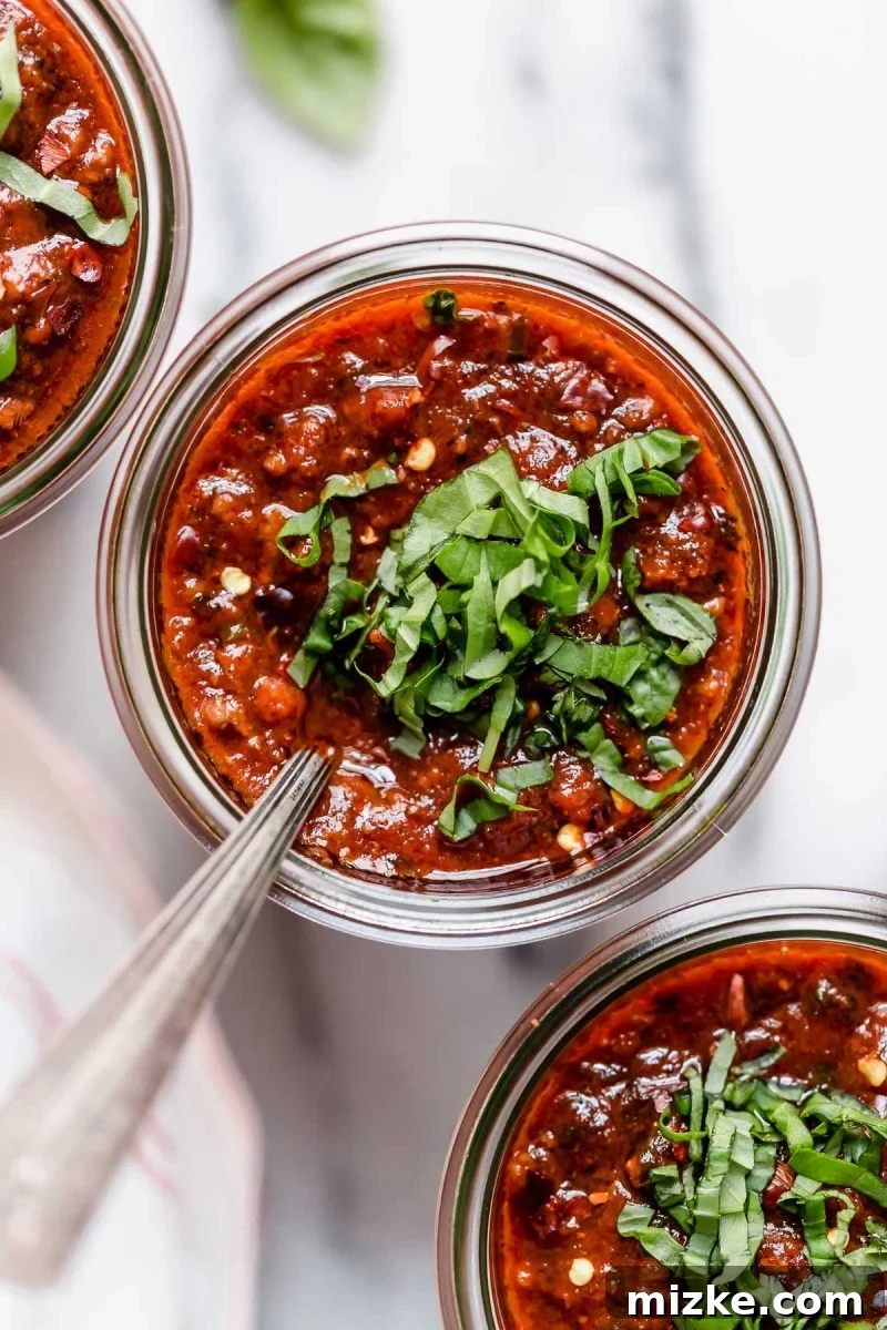 Great-Grandma's Heirloom Pasta Sauce 3 A rustic wooden spoon dipped into the simmering Great Grandma's Pasta Sauce, showing its thick texture and steam rising, promising rich flavor.