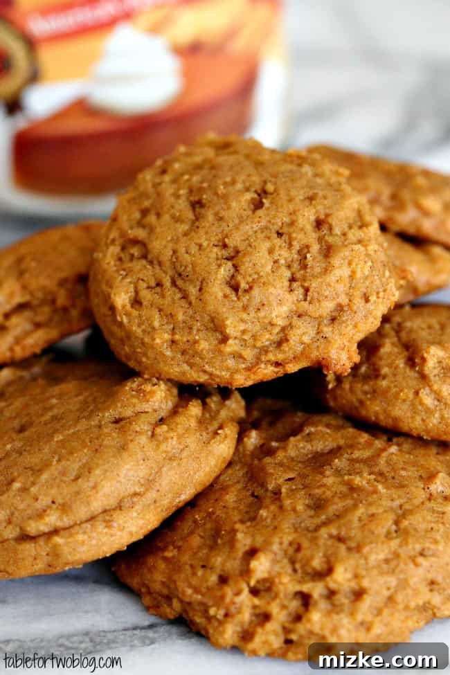 Spiced Pumpkin Peanut Butter Cookies 4 Three pumpkin peanut butter cookies stacked on a cooling rack