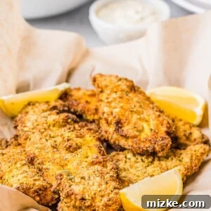 Lemon slices sit in the basket of catfish.