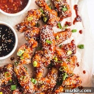 A square image of the sticky Korean chicken wings, garnished and ready to serve.