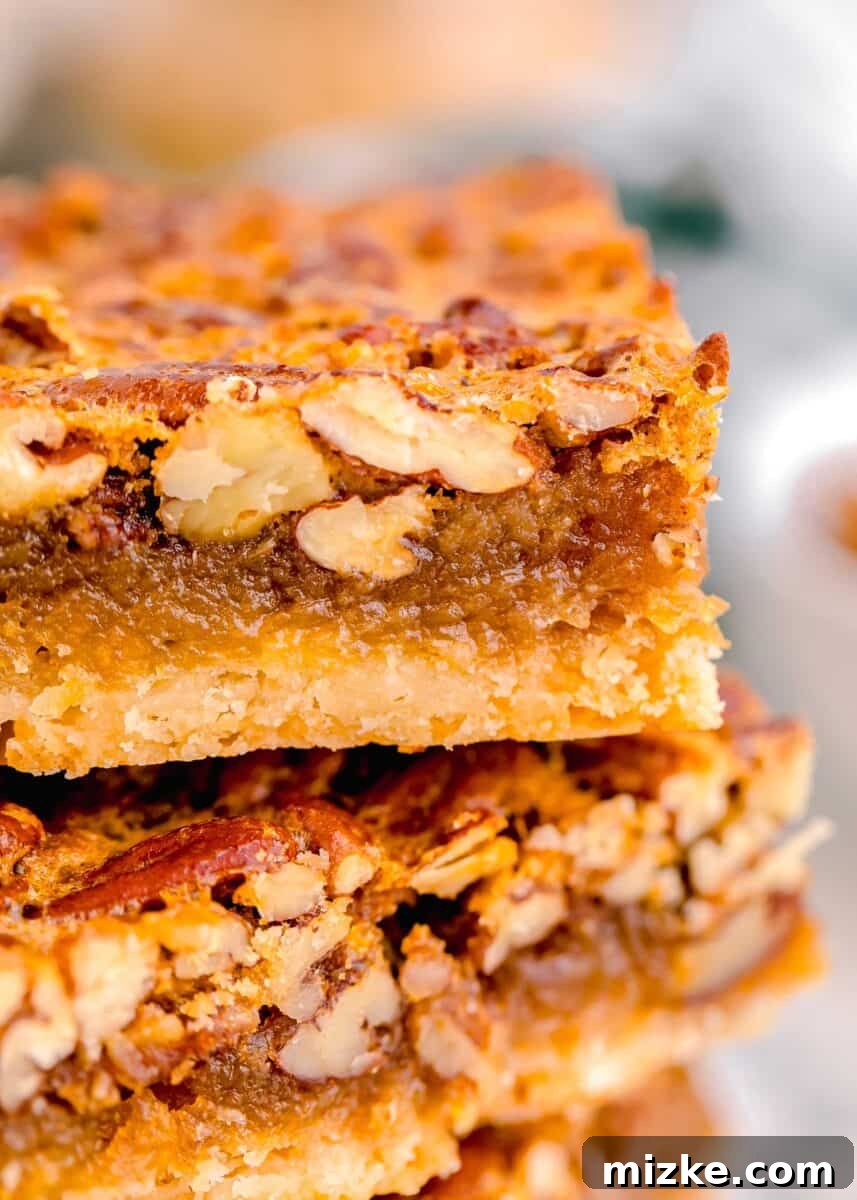 Golden Pecan Pie Squares 14 A close-up shot revealing the rich, gooey interior and crunchy pecan texture of a freshly baked pecan pie bar.