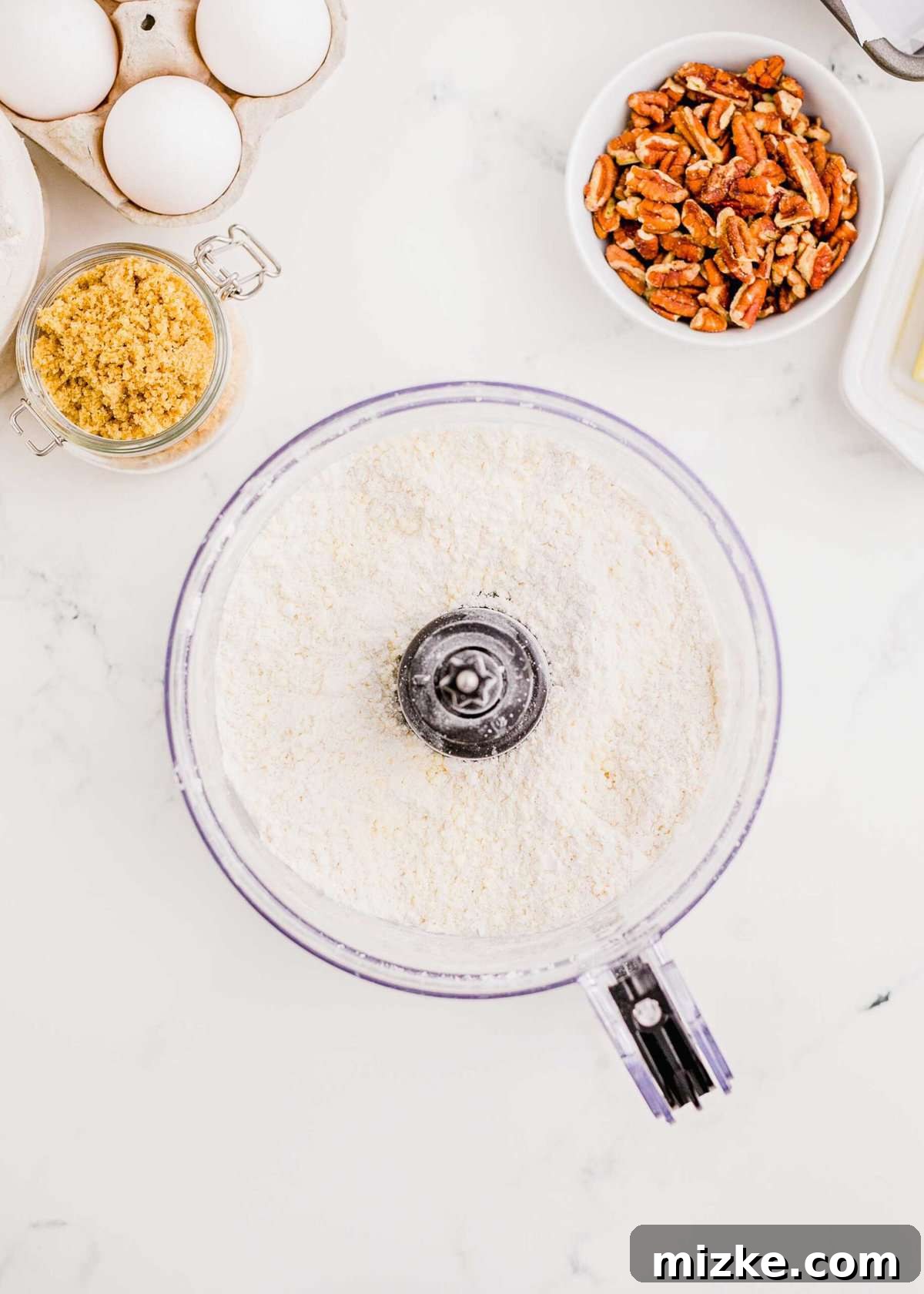 Golden Pecan Pie Squares 6 The butter, flour, and powdered sugar have been pulsed together in a food processor, resulting in a coarse, crumbly mixture that is perfect for the shortbread crust.