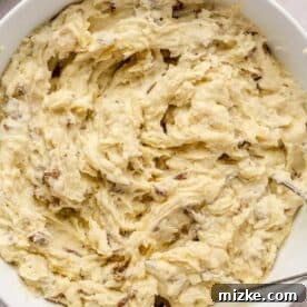 Heavenly Garlic Mashed Potatoes 10 The final creamy mashed potato mixture in a pristine white bowl, perfectly blended and ready to be served.