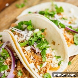 Easy Slow Cooker Chicken Tinga Tacos 6 A dish of Slow Cooker Chicken Tinga Tacos ready to be served