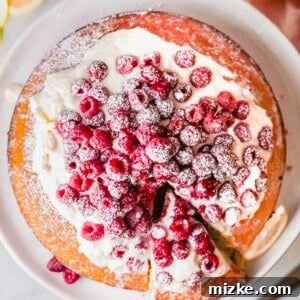 Raspberry Olive Oil Cake with fresh raspberries and whipped cream