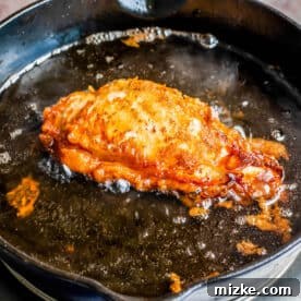 Buttermilk Fried Chicken Sandwich 8 fried chicken breast in bubbling hot oil in a cast iron skillet