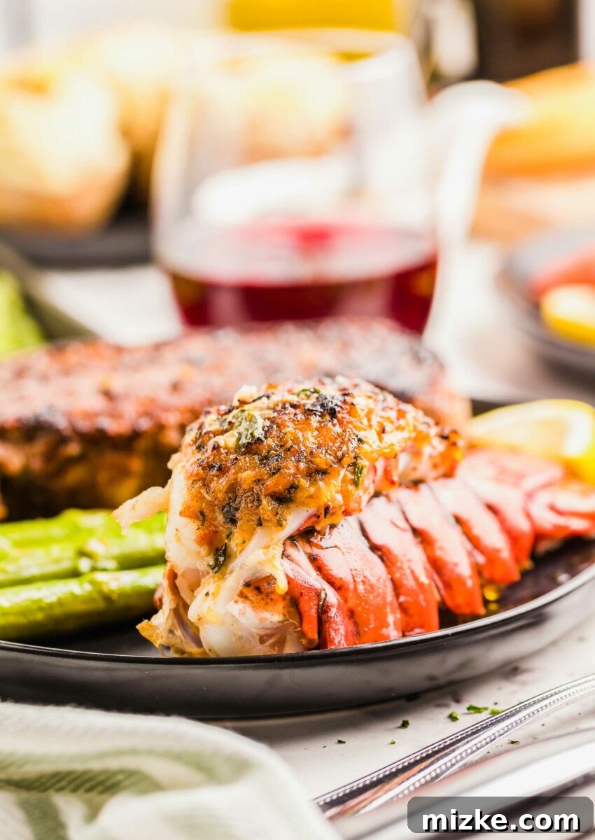 The Best of Both Worlds 5 A lobster tail is fully cooked on a black plate.