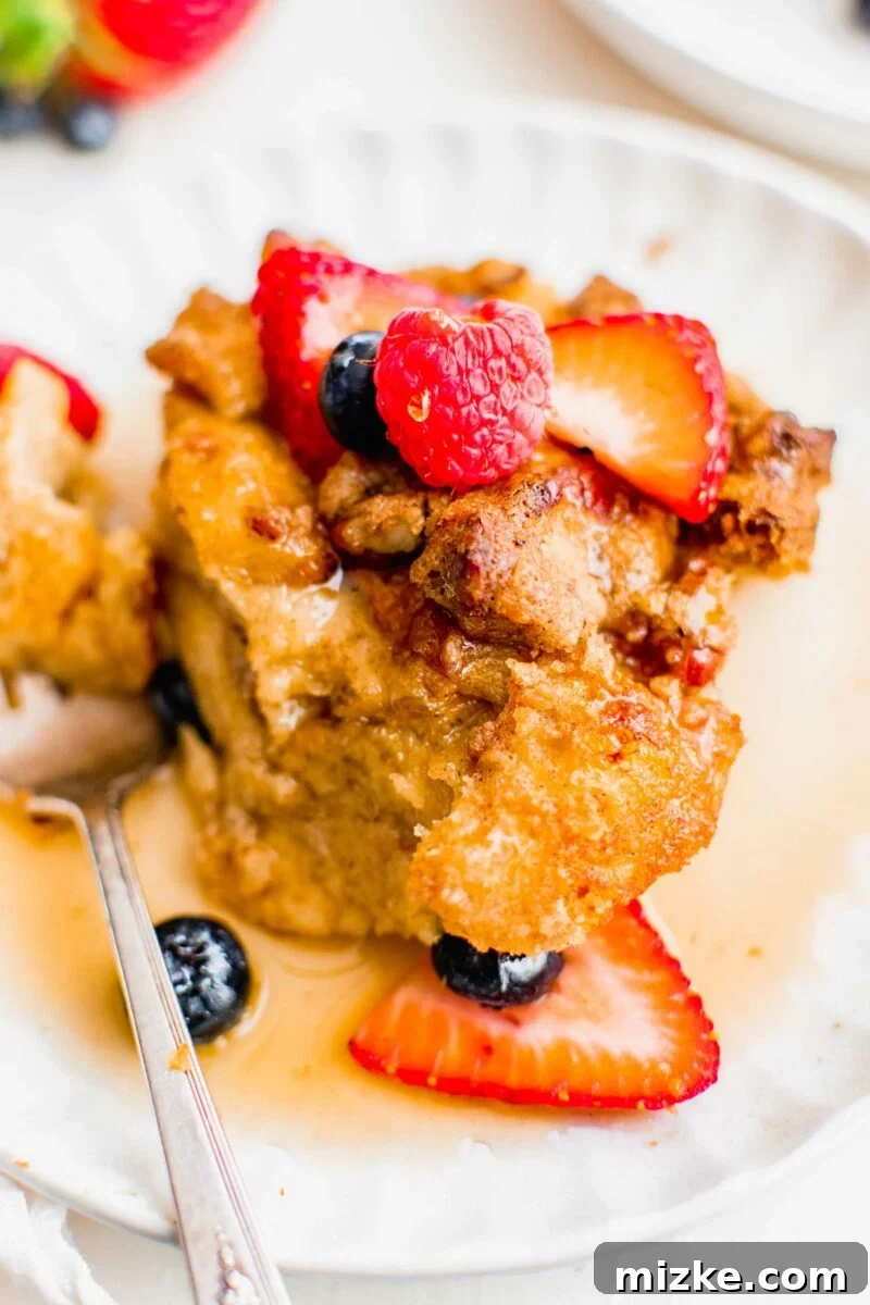 Irresistible Brown Sugar Streusel French Toast Bake 5 Berries sit atop a serving of breakfast casserole.