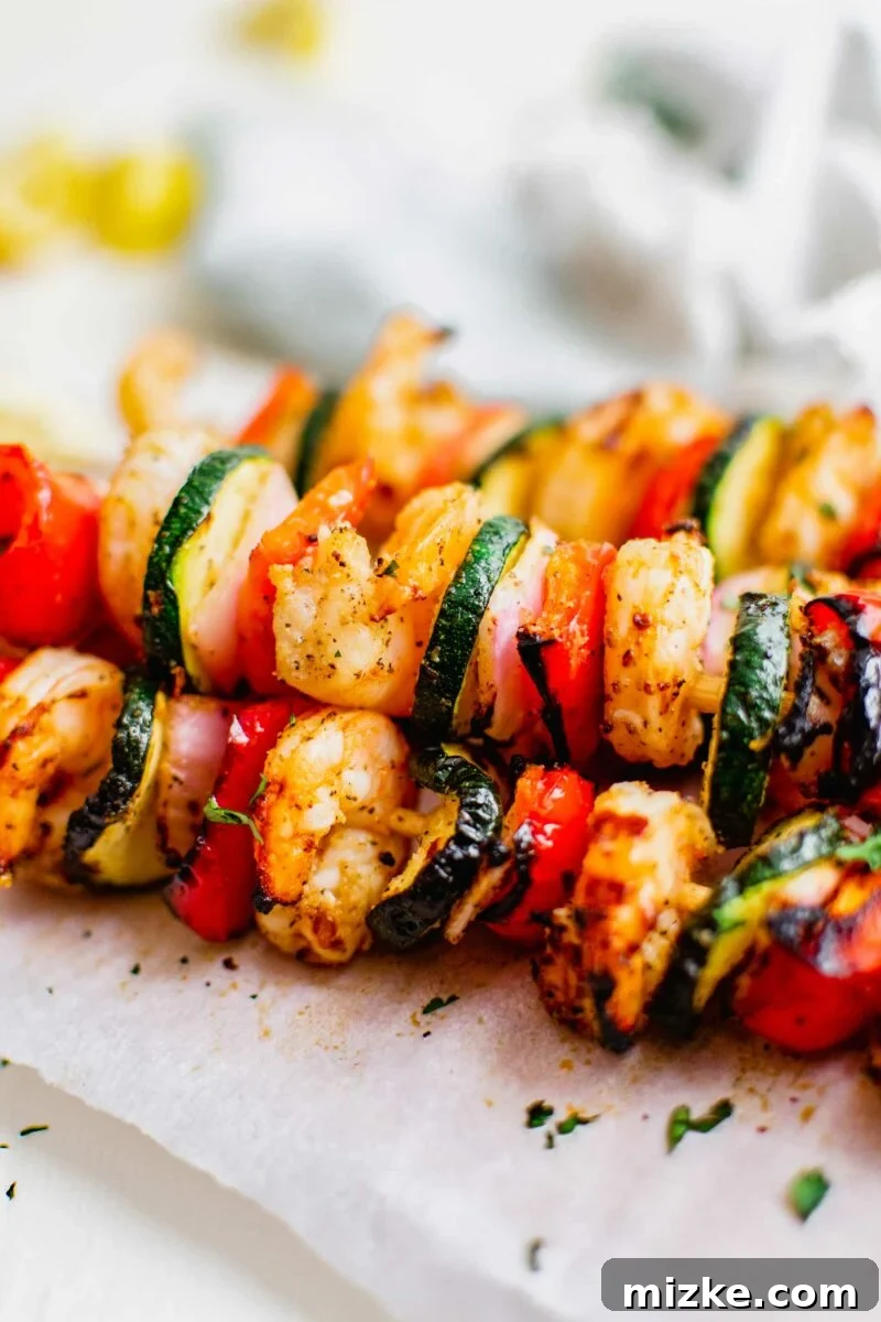 Smoky Grilled Shrimp Skewers 5 Grilled kebobs are placed on top of each other.
