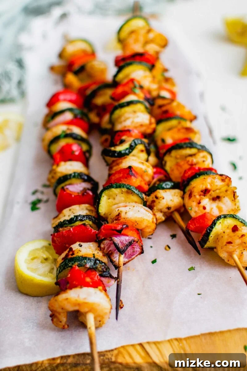 Smoky Grilled Shrimp Skewers 6 The ends of the wooden sticks are blackened, showing the kebobs have been grilled.