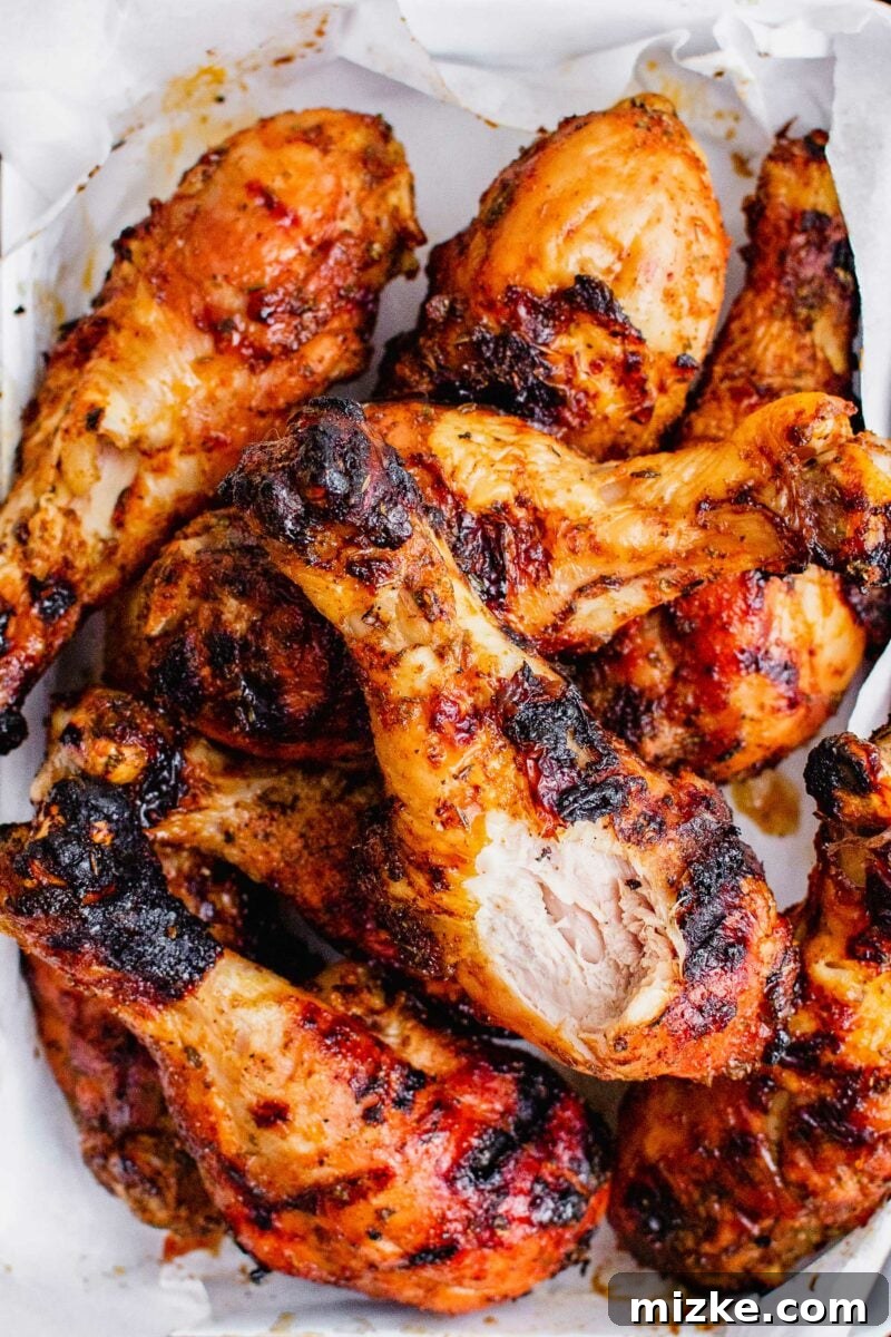 Smoky Dry Rub Grilled Drumsticks 5 A bite of a chicken leg has been removed to show perfectly cooked white meat.