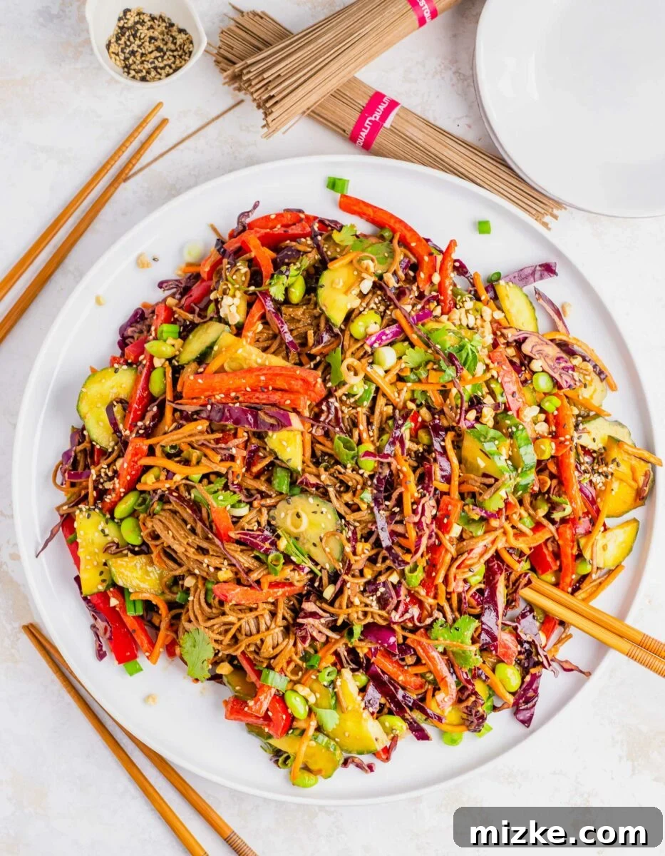 Velvety Peanut Soba Salad 3 A large plate os soba noodle salad is garnished with sesame seeds.