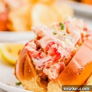A close-up of a homemade lobster roll with golden brioche bun and creamy lobster filling.