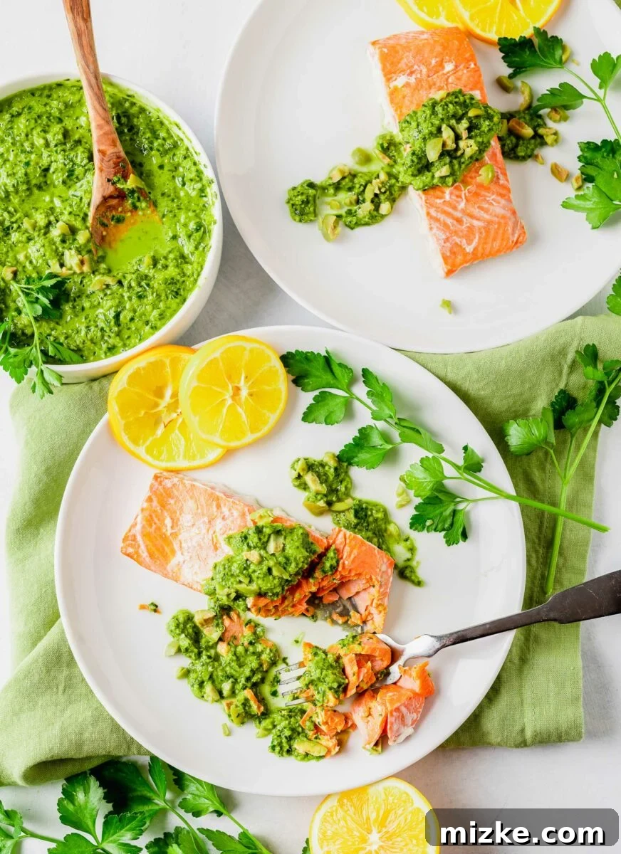 Zesty Green Olive Gremolata Roasted Salmon 3 Two white plates have servings of garnished salmon.