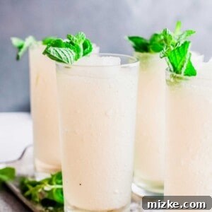 Minted Bourbon Frost 6 Close-up of a perfectly blended Frozen Mint Julep in a glass, garnished with fresh mint sprigs and invitingly frosty.