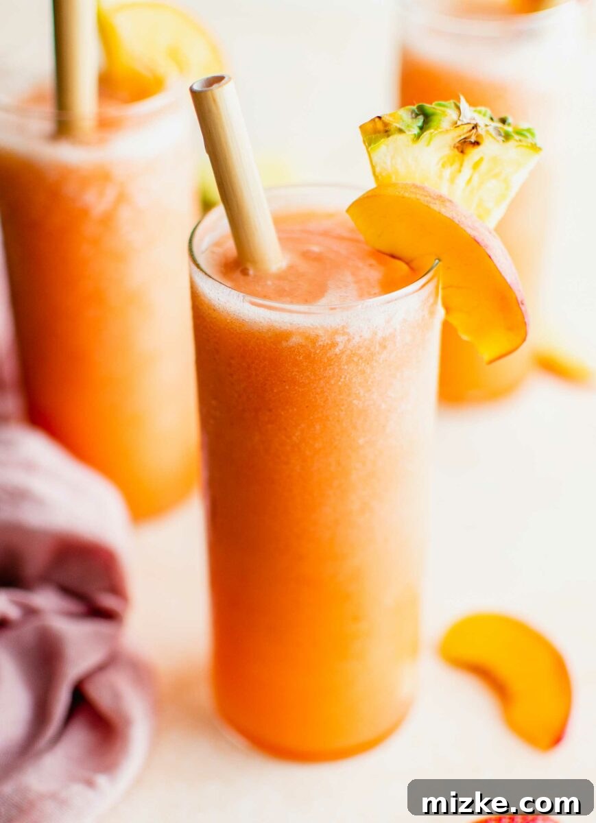 Summer's Spirited Slush 6 A vibrant, boozy fruit slushy in a glass, garnished with fresh fruit, invitingly positioned for a summer refresh.