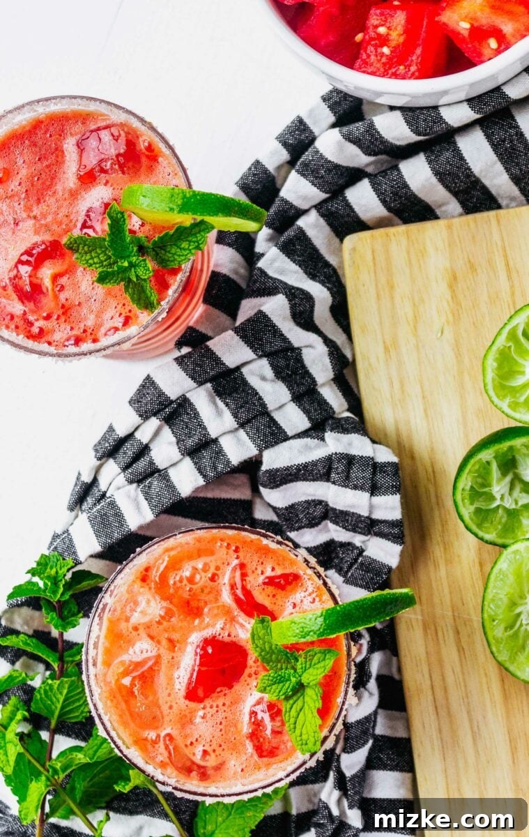 Watermelon Mint Tequila Splash 4 Two margaritas are placed on a black and white tea cloth.