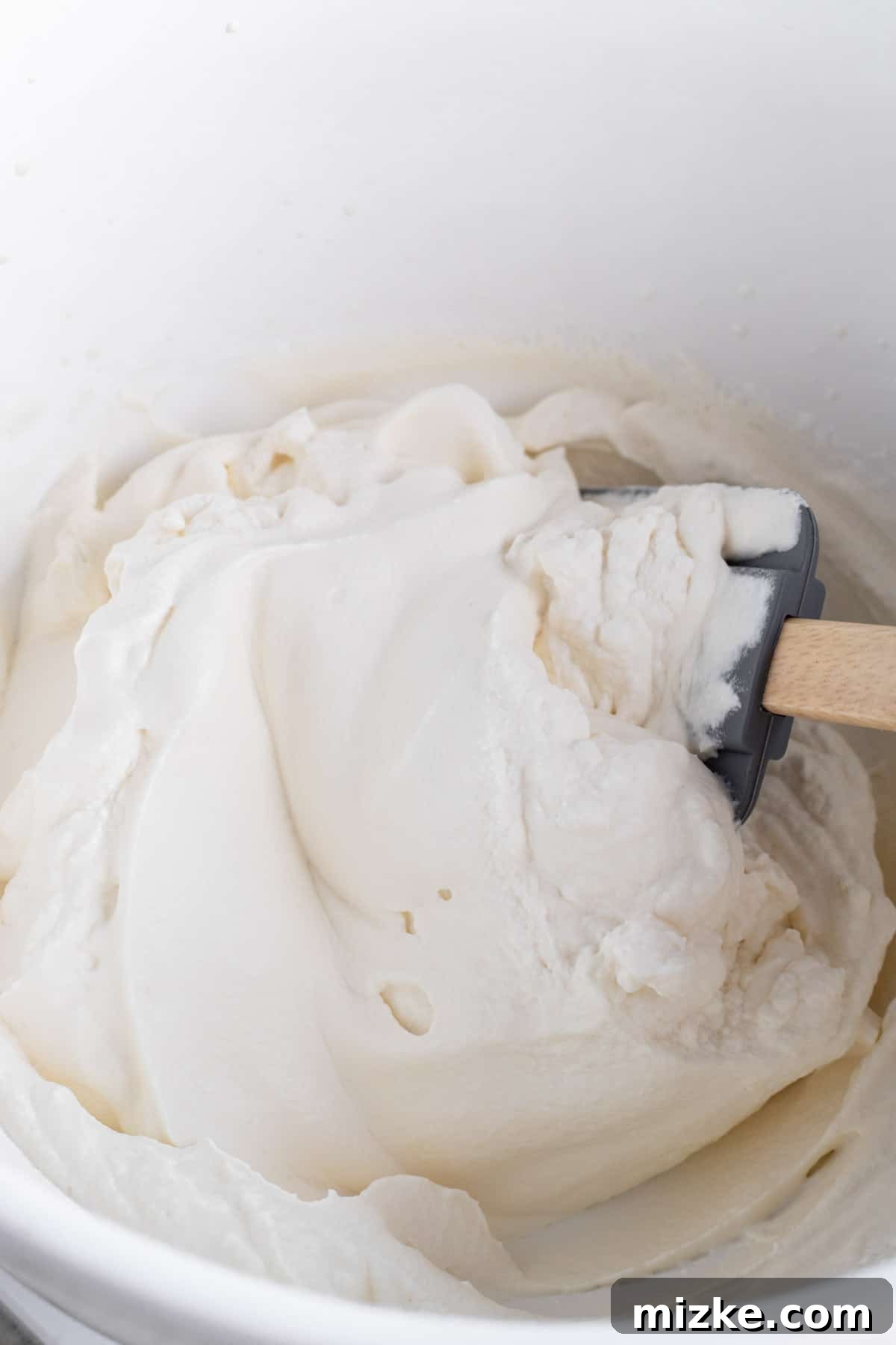 Midnight Sesame Dream 4 heavy cream mixture being mixed together with a silicone spatula