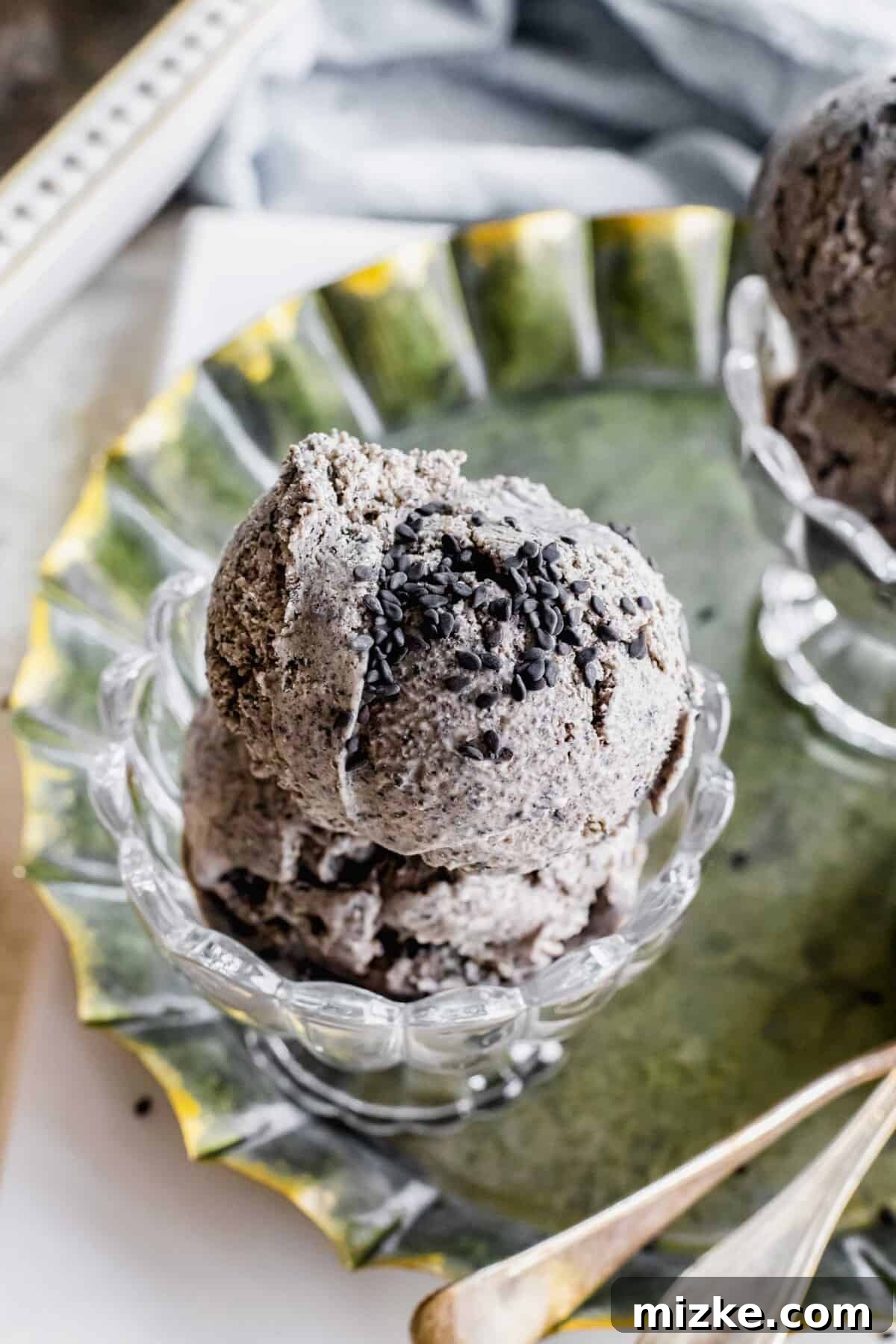 Midnight Sesame Dream 9 Sesame seeds garnish a scoop of black ice cream.