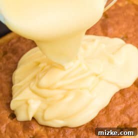 Ultimate Banana Pudding Poke Cake 6 Banana pudding is being poured on top of a cake.