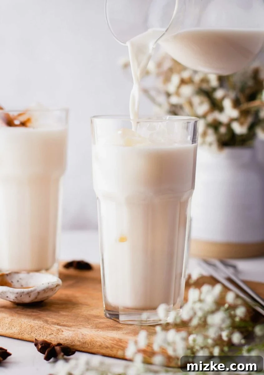 Whip Up Homemade Horchata Easily 2 Horchata is being poured into a glass, showcasing its creamy texture.