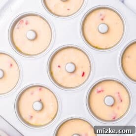 Strawberry Oven Donuts 10 donut batter piped into a metal donut pan