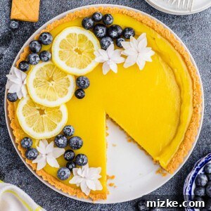 Bright Lemon Tart 12 A close-up of a beautifully decorated lemon tart, showcasing its golden crust and smooth yellow filling, garnished with fresh fruit and edible flowers, ready to be enjoyed.
