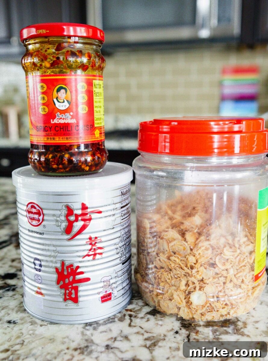 The Palette of Chinese Flavors 5 A trio of Asian chili condiments: chili crisp, sacha sauce, and fried shallots.