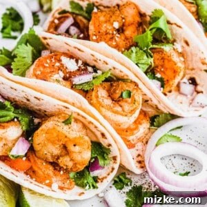 A close-up of a grilled shrimp taco, showcasing the vibrant ingredients.