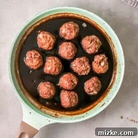 Steppe-Style Meatballs 8 Freshly cooked meatballs gently placed into a saucepan filled with the rich, sticky Mongolian sauce, ready to be coated.