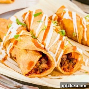 Several air fried taquitos are placed on corn husks.