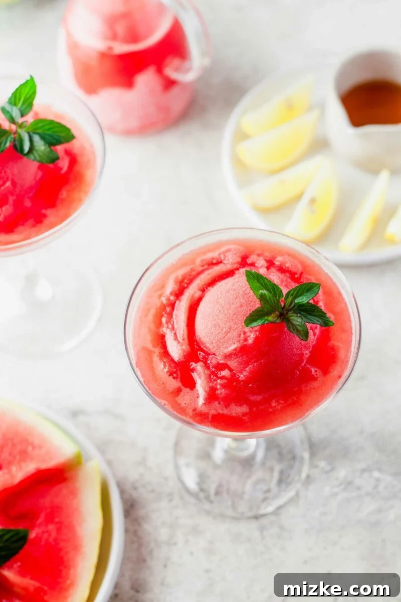 A glass is filled to the brim with watermelon frose. 