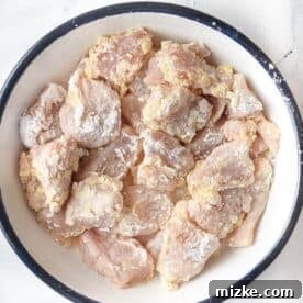 Chicken thigh pieces coated in egg and cornstarch