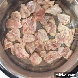 Battered chicken pieces shallow frying in an Instant Pot