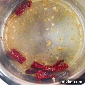 Garlic, ginger, and red pepper cooking in the Instant Pot