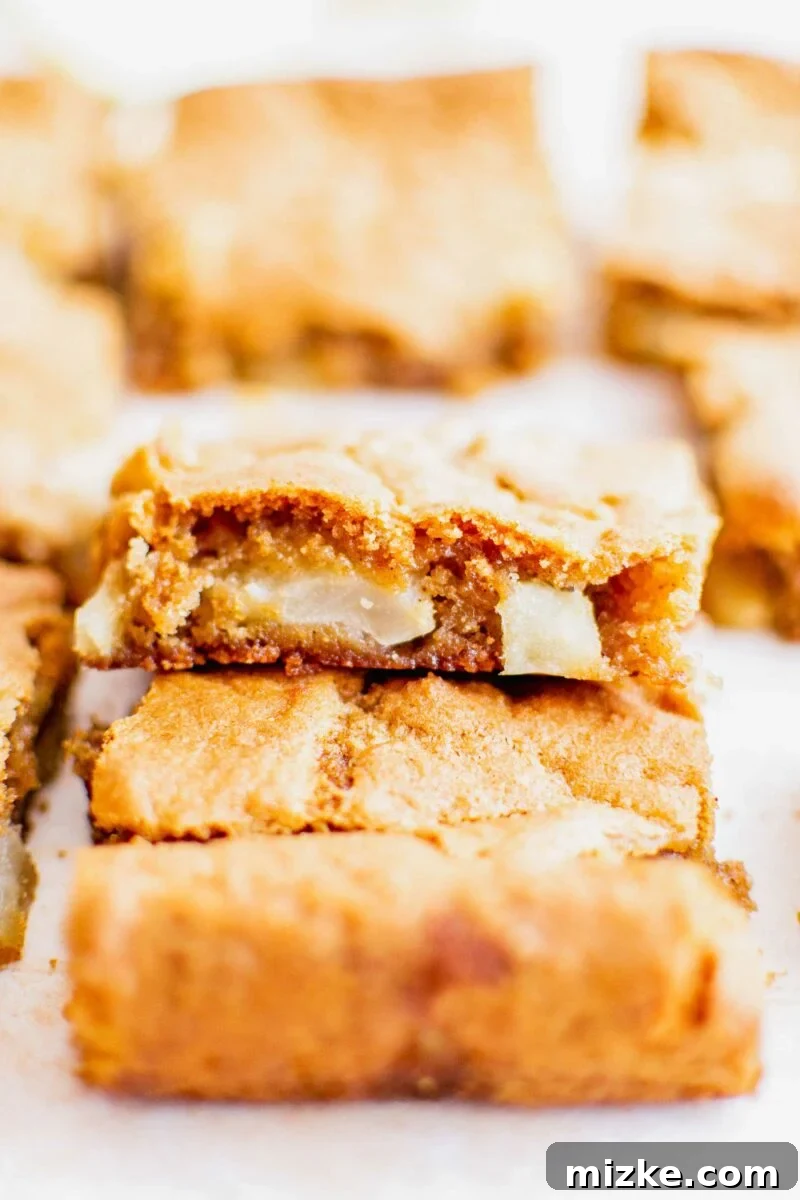 Spiced Apple Blondies 3 Slices of blondies are stacked on top of one another.