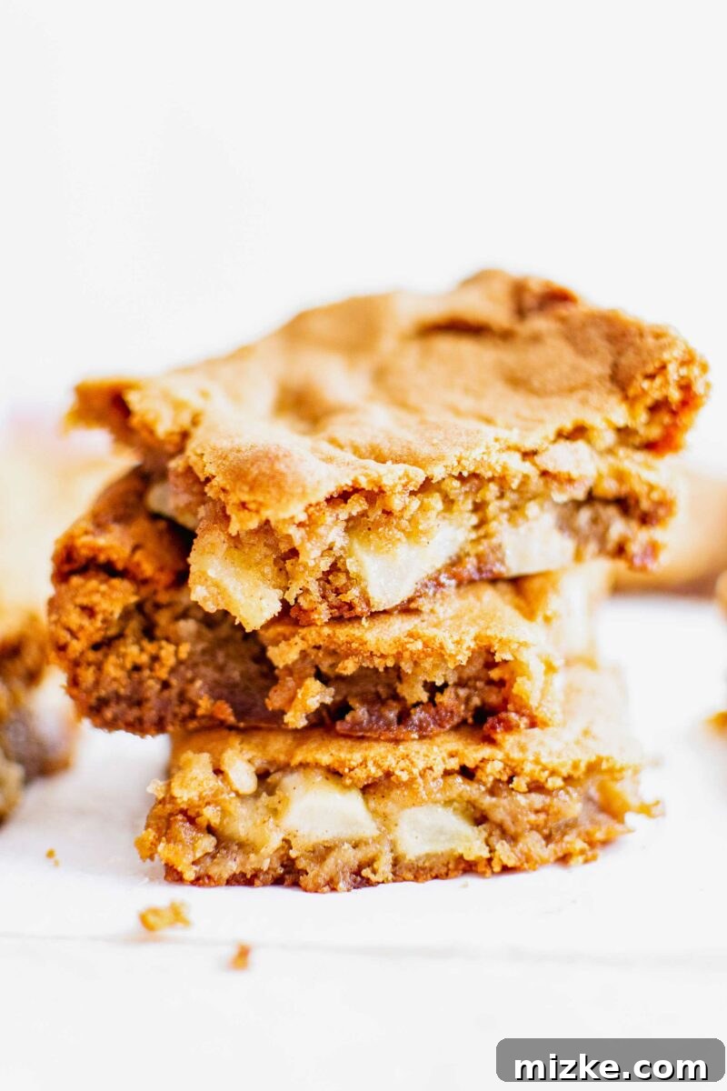 Spiced Apple Blondies 4 Three slices of blondies are stacked on top of one another.