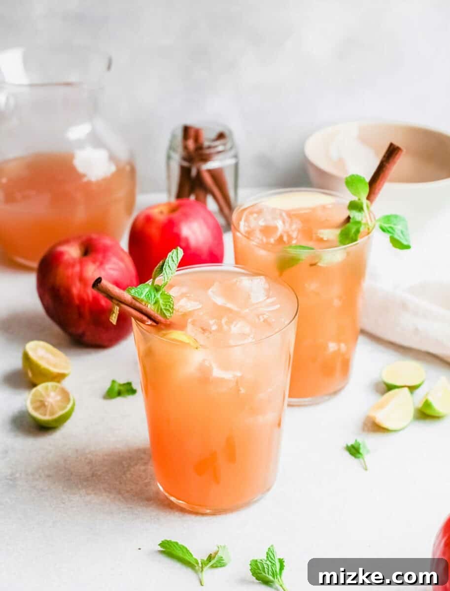 Crisp Apple Mojito 2 Two mojitos are garnished with cinnamon sticks and mint leaves, capturing the essence of fall.