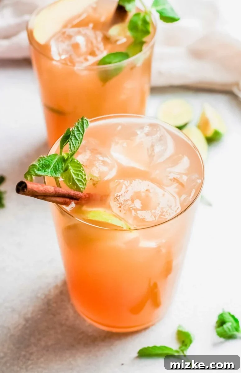 Crisp Apple Mojito 4 A mojito is garnished with a mint sprig and a cinnamon stick, ready for a fall celebration.