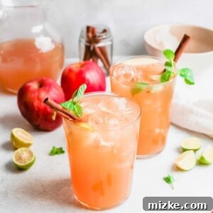 A festive Apple Cider Mojito garnished with a cinnamon stick.