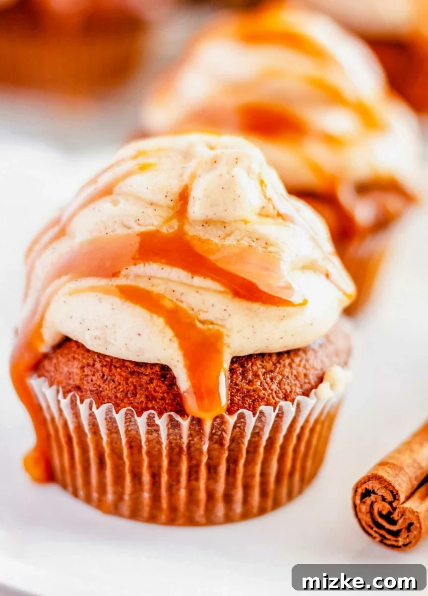 Salted caramel drizzle is placed on top of frosting and a cupcake.