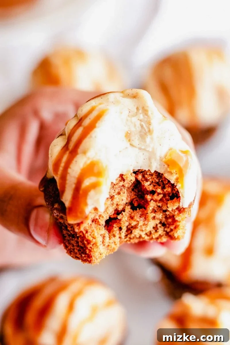 A bite has been taken out of a cupcake.
