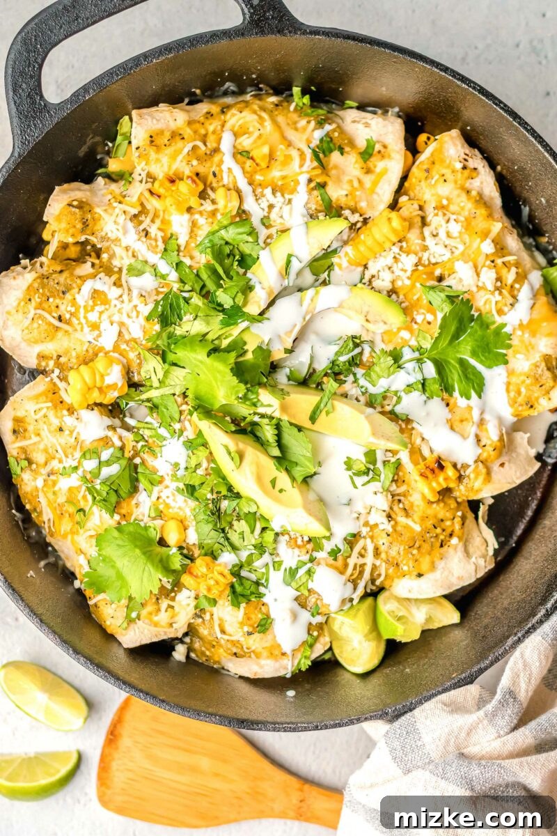 One-Pan Smoky Chipotle Chicken Enchiladas 7 A large black Dutch oven filled with bubbling chicken enchiladas, suggesting a hearty, comforting meal.
