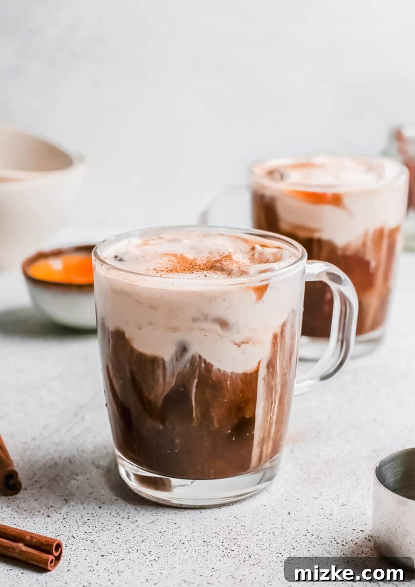 Starbucks Inspired Pumpkin Cream Cold Brew 2 A refreshing glass of homemade Pumpkin Cream Cold Brew, topped with a thick layer of creamy pumpkin foam and a sprinkle of cinnamon, ready for fall.