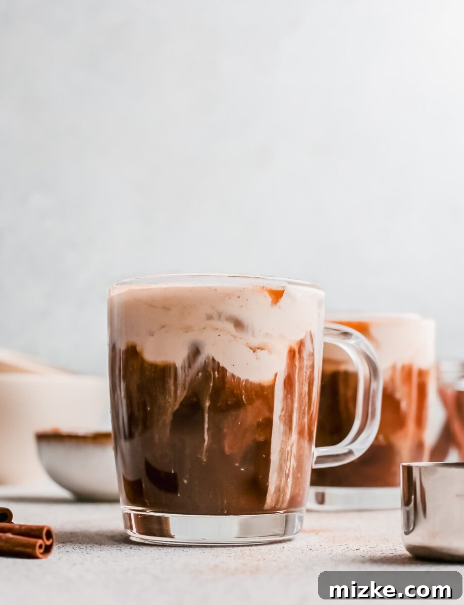 Starbucks Inspired Pumpkin Cream Cold Brew 4 Ingredients laid out on a table, including a can of pumpkin puree, vanilla extract, pumpkin pie spice, and a carton of whipping cream, ready for making pumpkin cream cold brew.