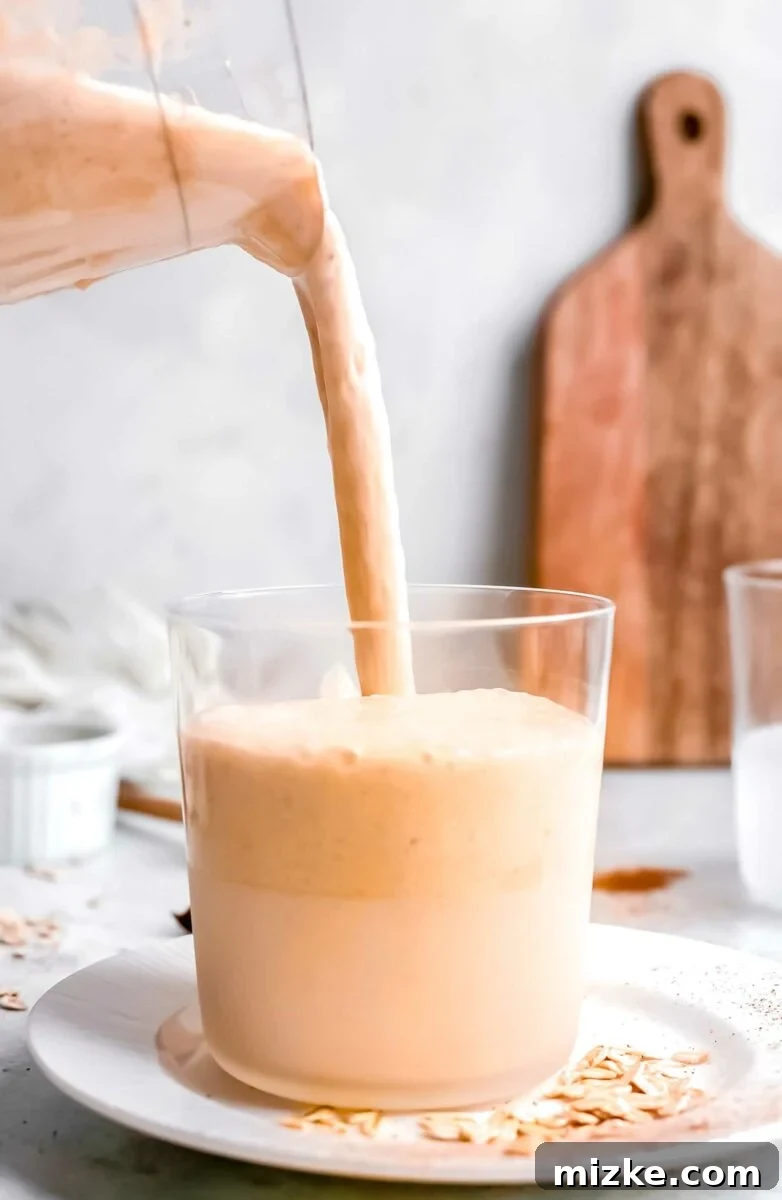 Autumn Pumpkin Bliss 3 Pumpkin pie smoothie is being poured into a glass.