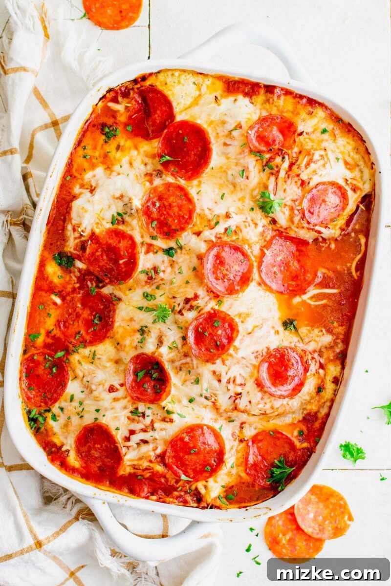 Pizza Bomb Chicken 2 A white casserole dish is totally filled with pizza stuffed chicken.