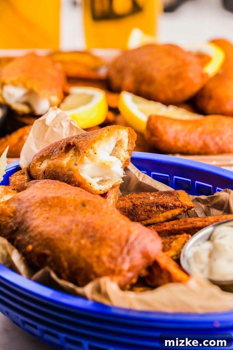 Golden Fried Perfection 4 A blue basket is filled with fried fish and chips.